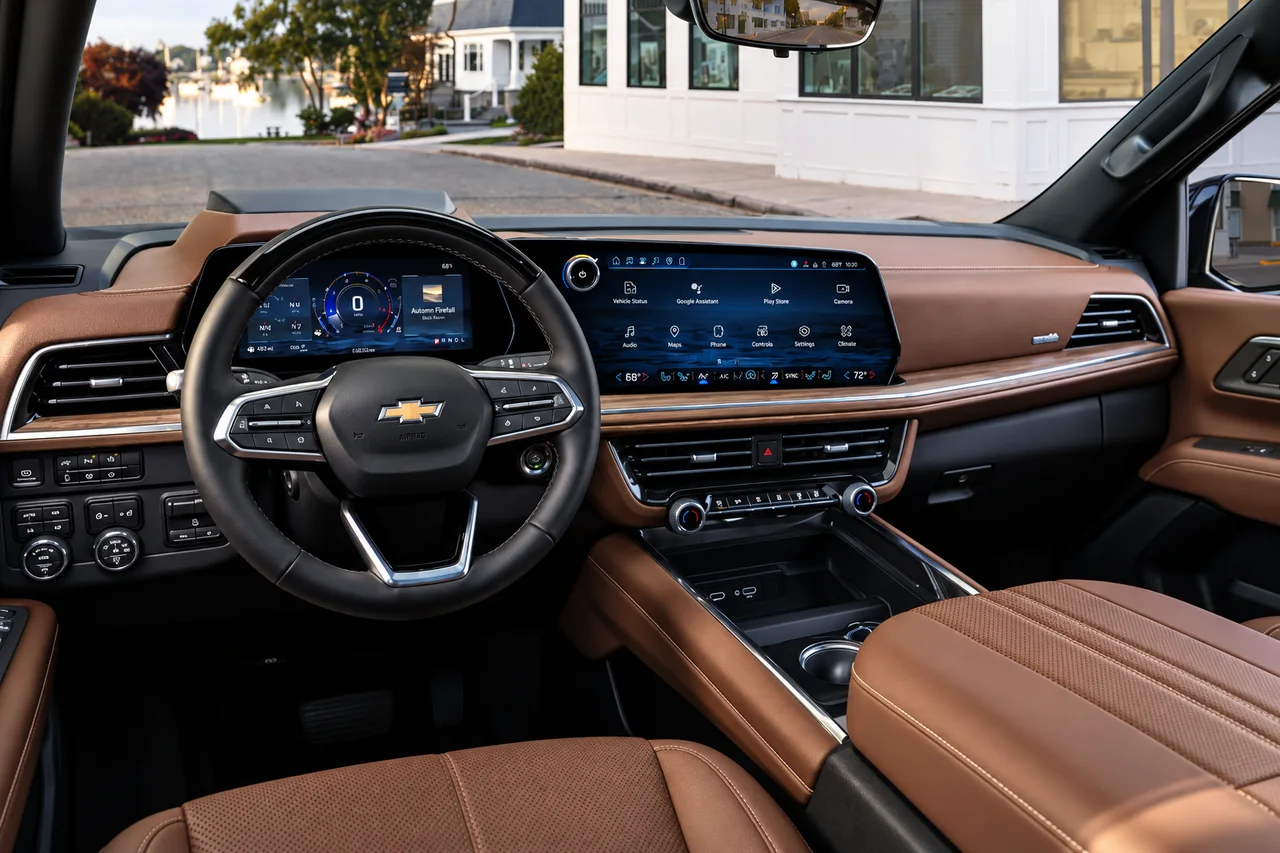 AI-enhanced reference of a Suburban dashboard with brown stitched trim, a black Chevrolet steering wheel, a digital instrument display and a wide center touchscreen.